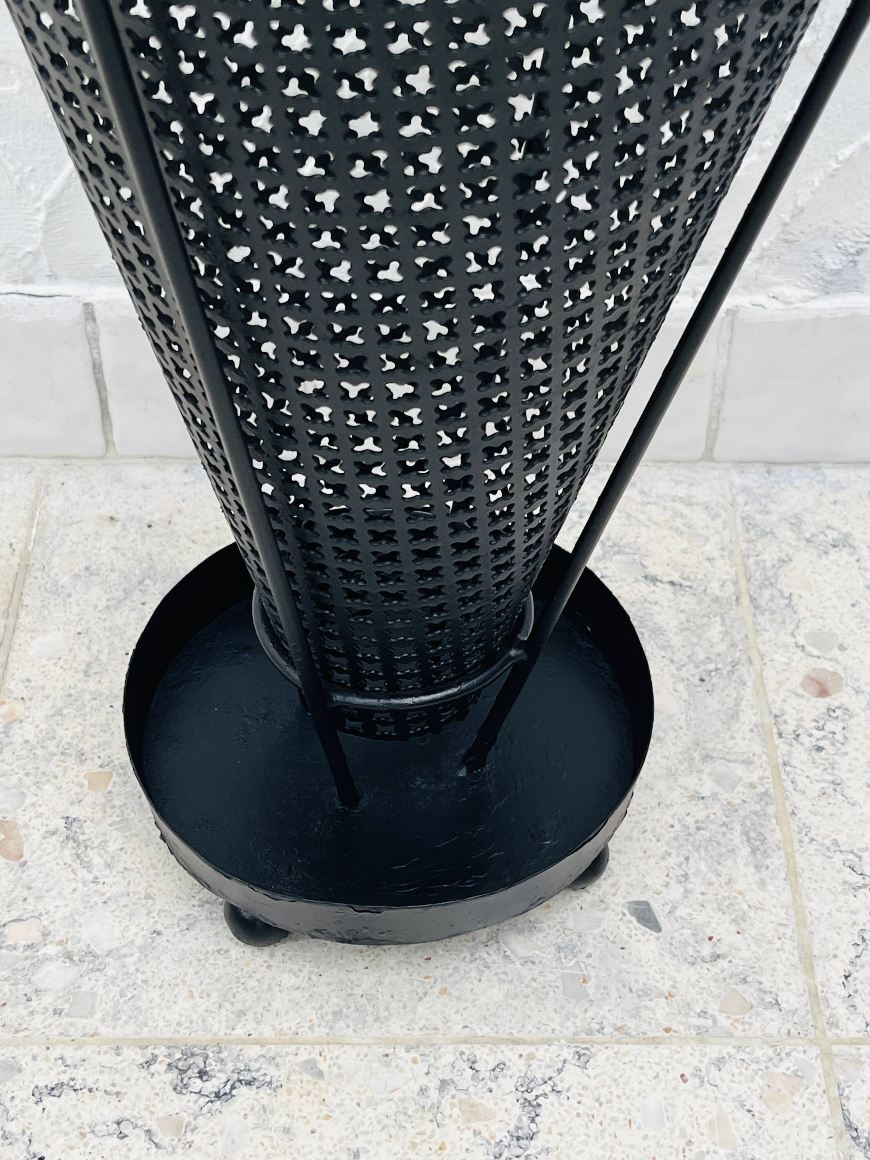 Vintage black perforated metal and brass umbrella stand