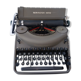 portable Remington typewriter with its suitcase and original cover