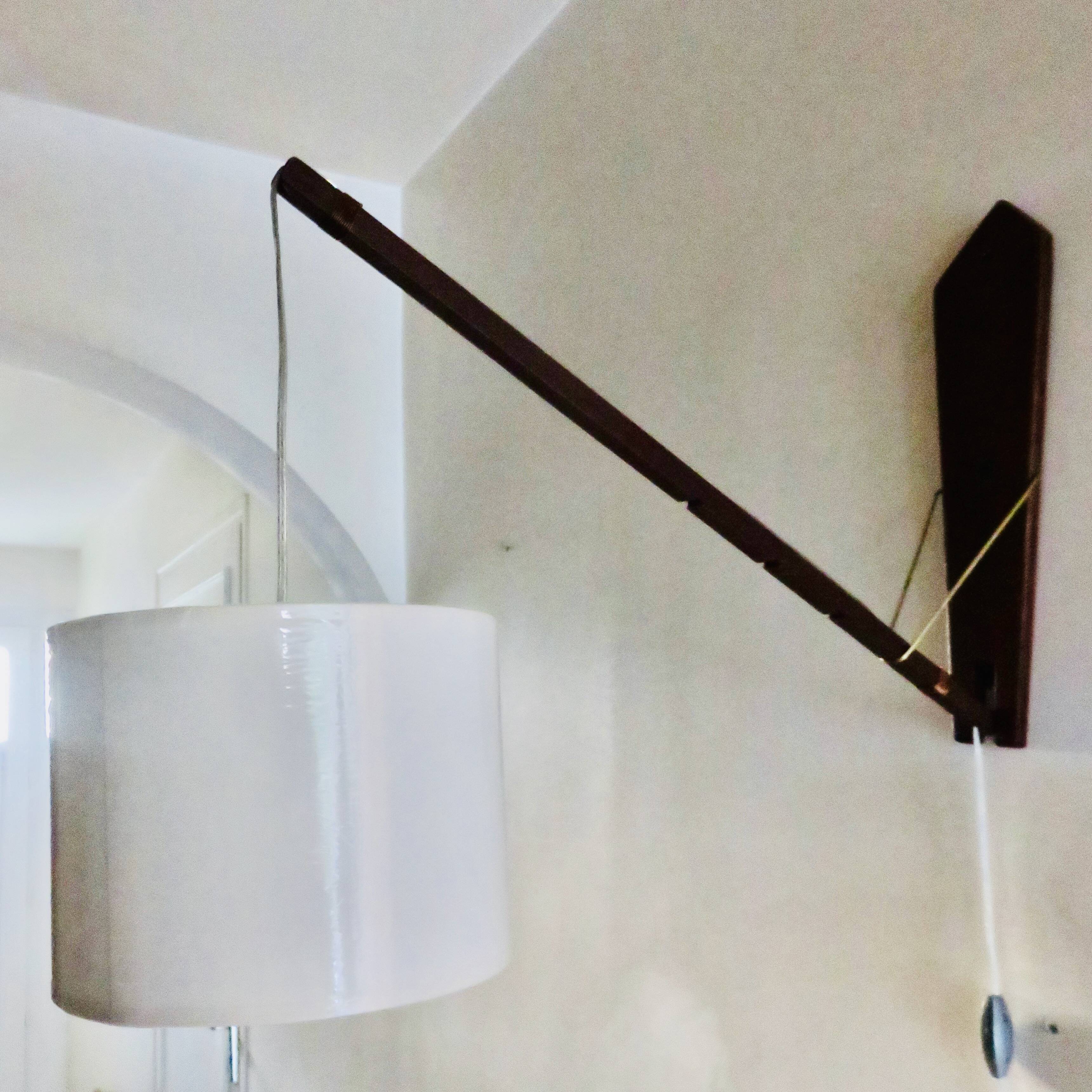 Teak wall light with articulated arm. Denmark 1960
