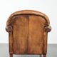 Sheepskin armchair with a beautiful vintage look and decorative nail finish