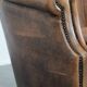 Club chair made of sheepskin leather finished with decorative nails