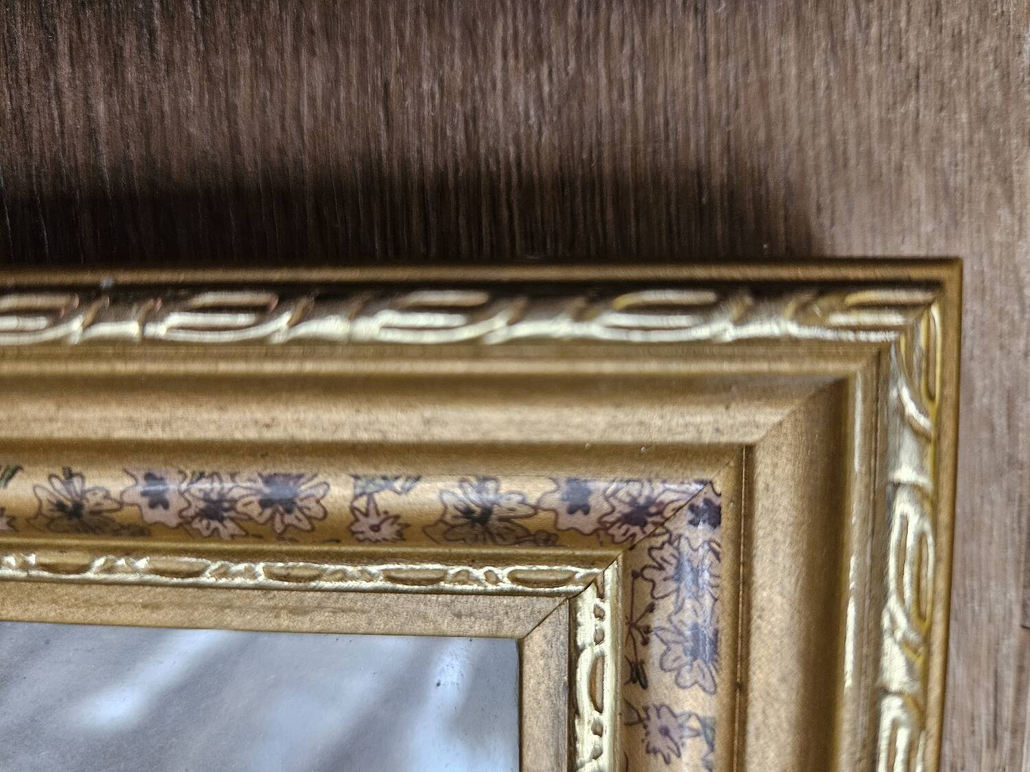 Golden wooden frame with floral patterns