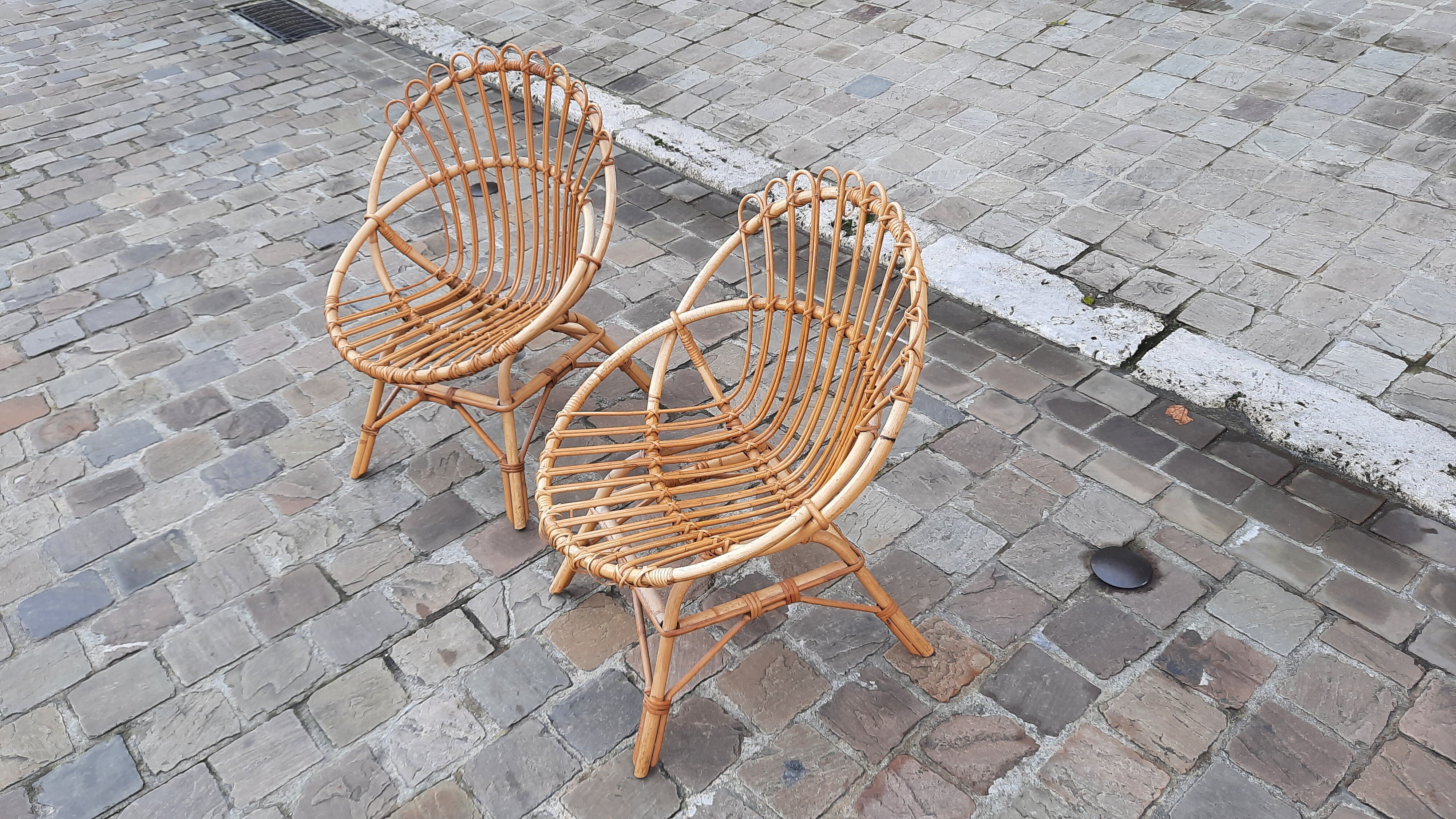 Pairs of shell rattan armchairs from the 50