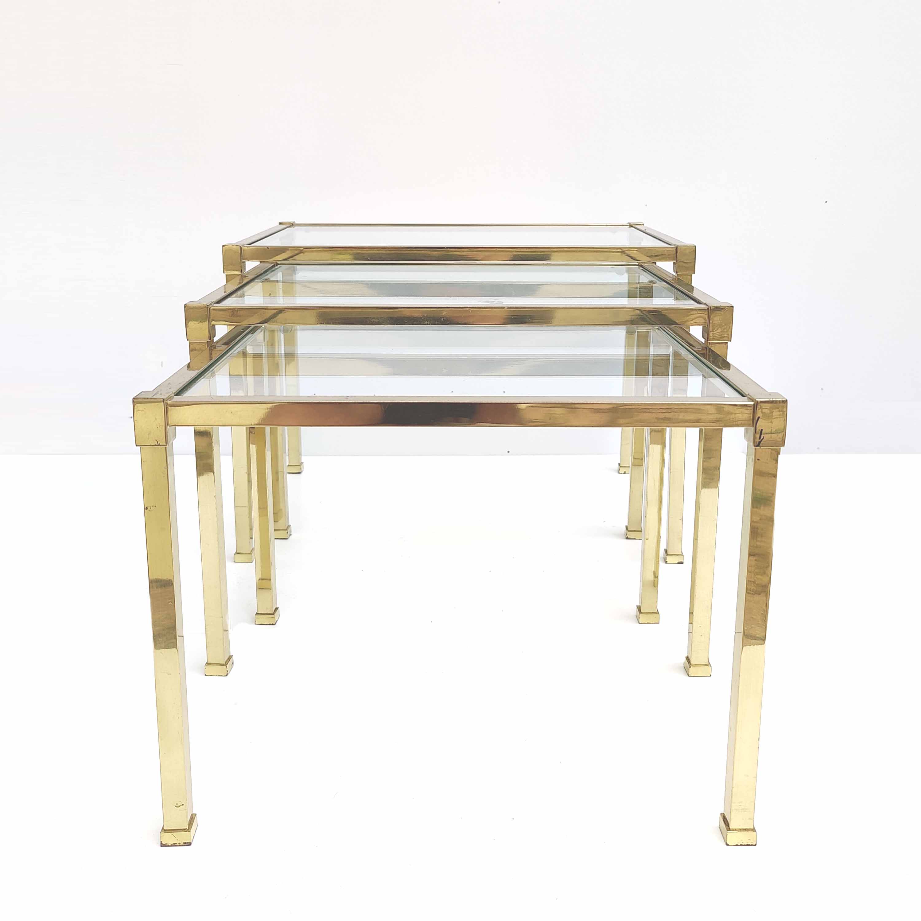 Brass and glass trundle tables