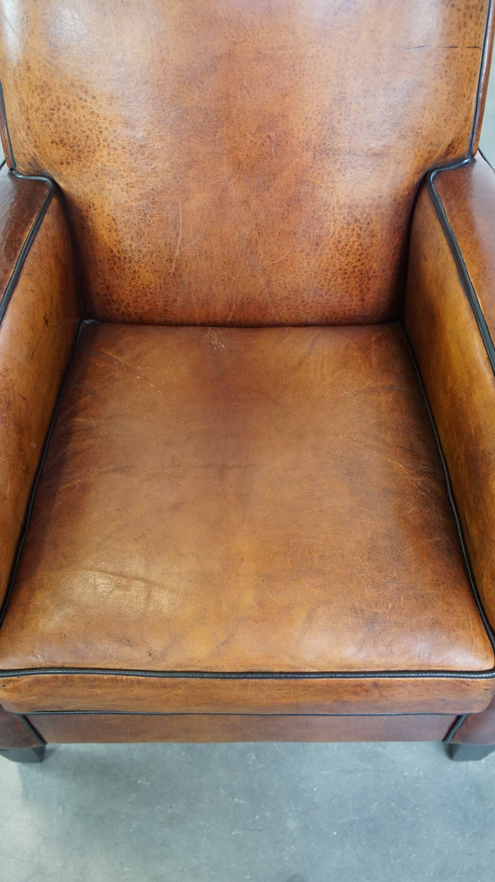Art Deco design sheepskin leather armchair with a stunning patina