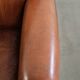 Sheepskin armchair with comfortable seat and finished with decorative nails