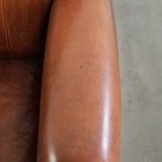 Sheepskin armchair with comfortable seat and finished with decorative nails
