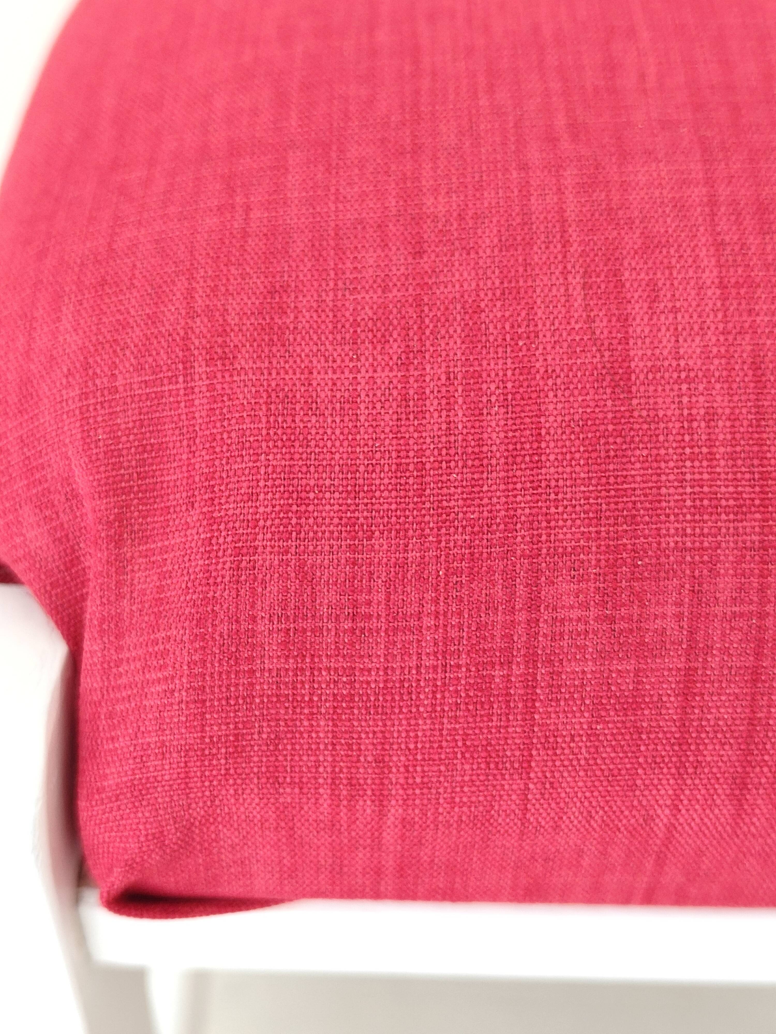 White pine stool with a red seat.