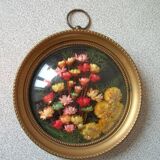Old medallion frame bouquet of dried flowers glass and plastic retro decoration