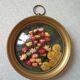 Old medallion frame bouquet of dried flowers glass and plastic retro decoration
