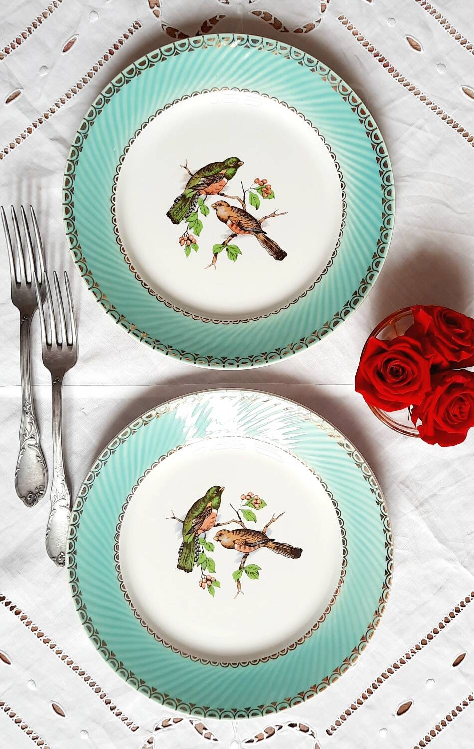 Old mismatched earthenware dinner plates with gold accompanied by a dish