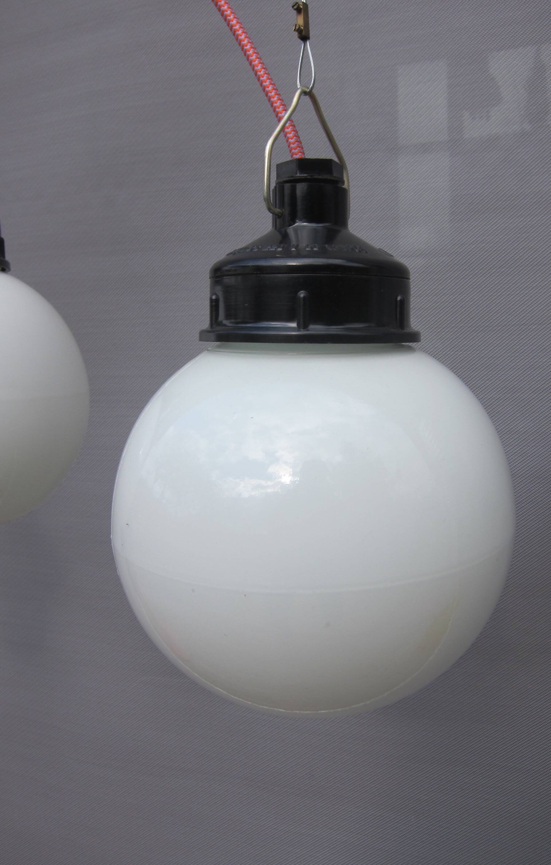 Trio of opal glass and bakelite globe pendant lights