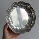 Silver-plated metal basket on rockwork feet