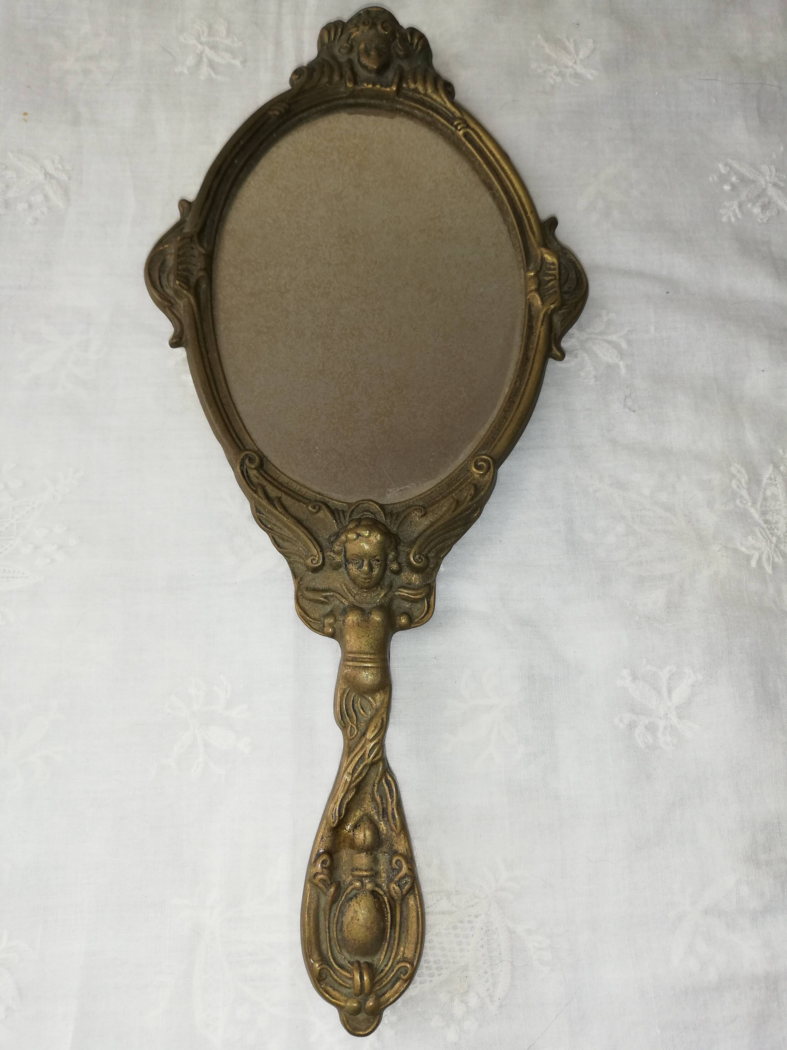 Old hand-facing mirror in gilded bronze