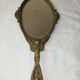Ancien miroir face à main en bronze doré