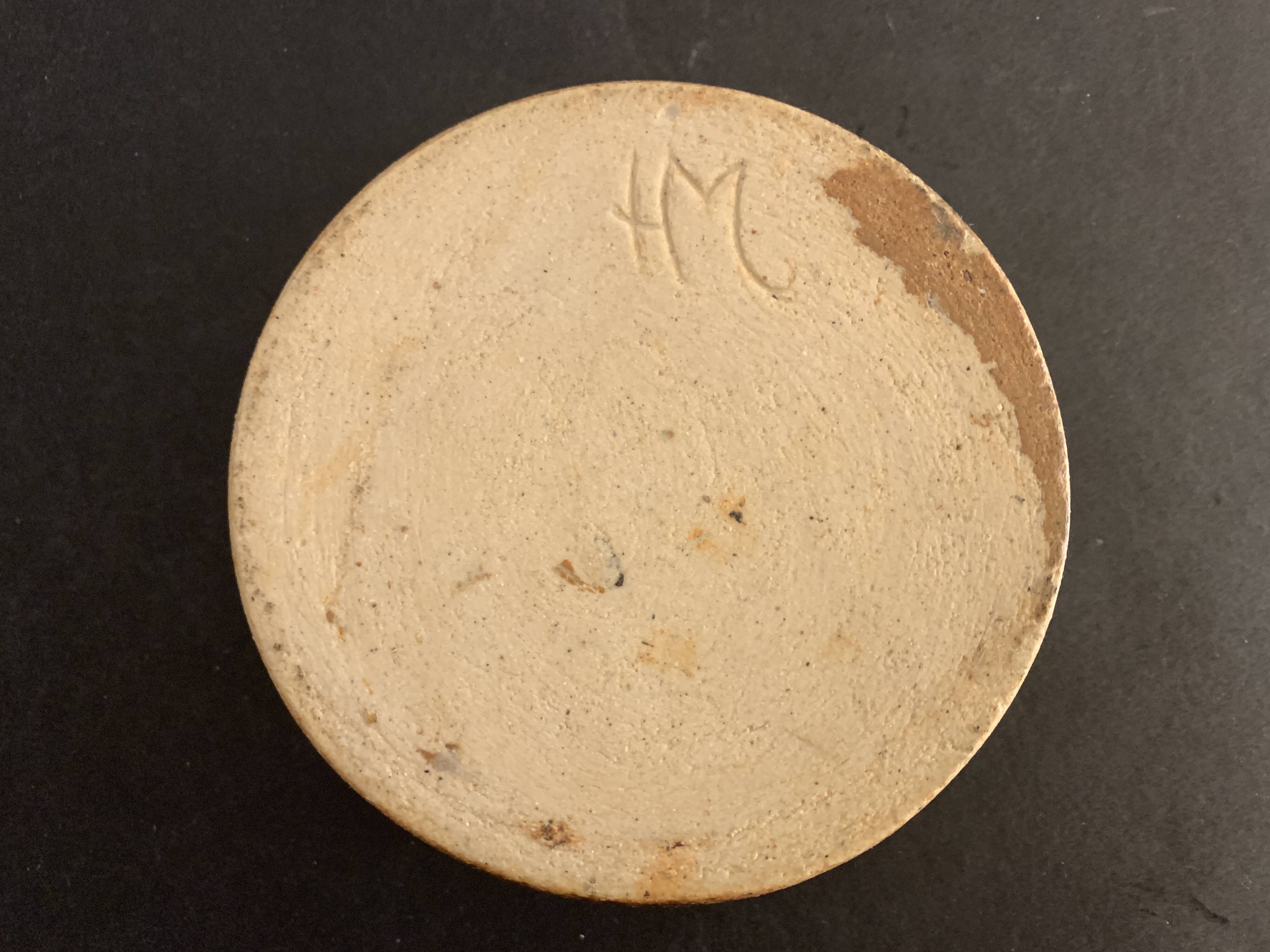 Round ashtray signed in sandstone with glazed interior