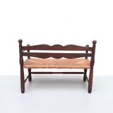 Vintage bench with wooden backrest and structure and mulched seat