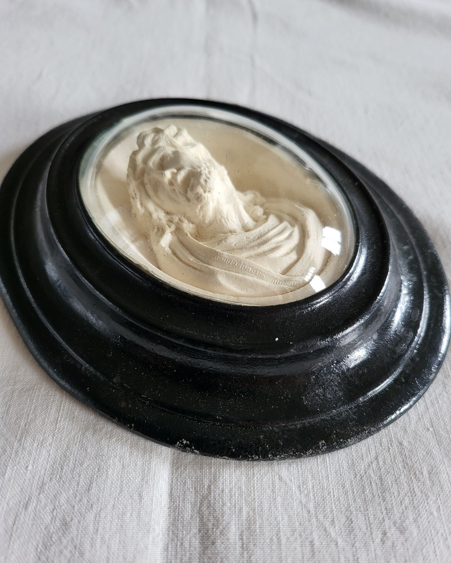 Ancient religious medallion, Jesus Christ in plaster with a blackened wooden frame.
