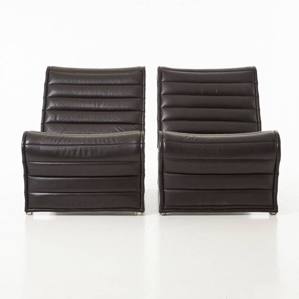 Modern black leather lounge chairs with an aluminium frame.