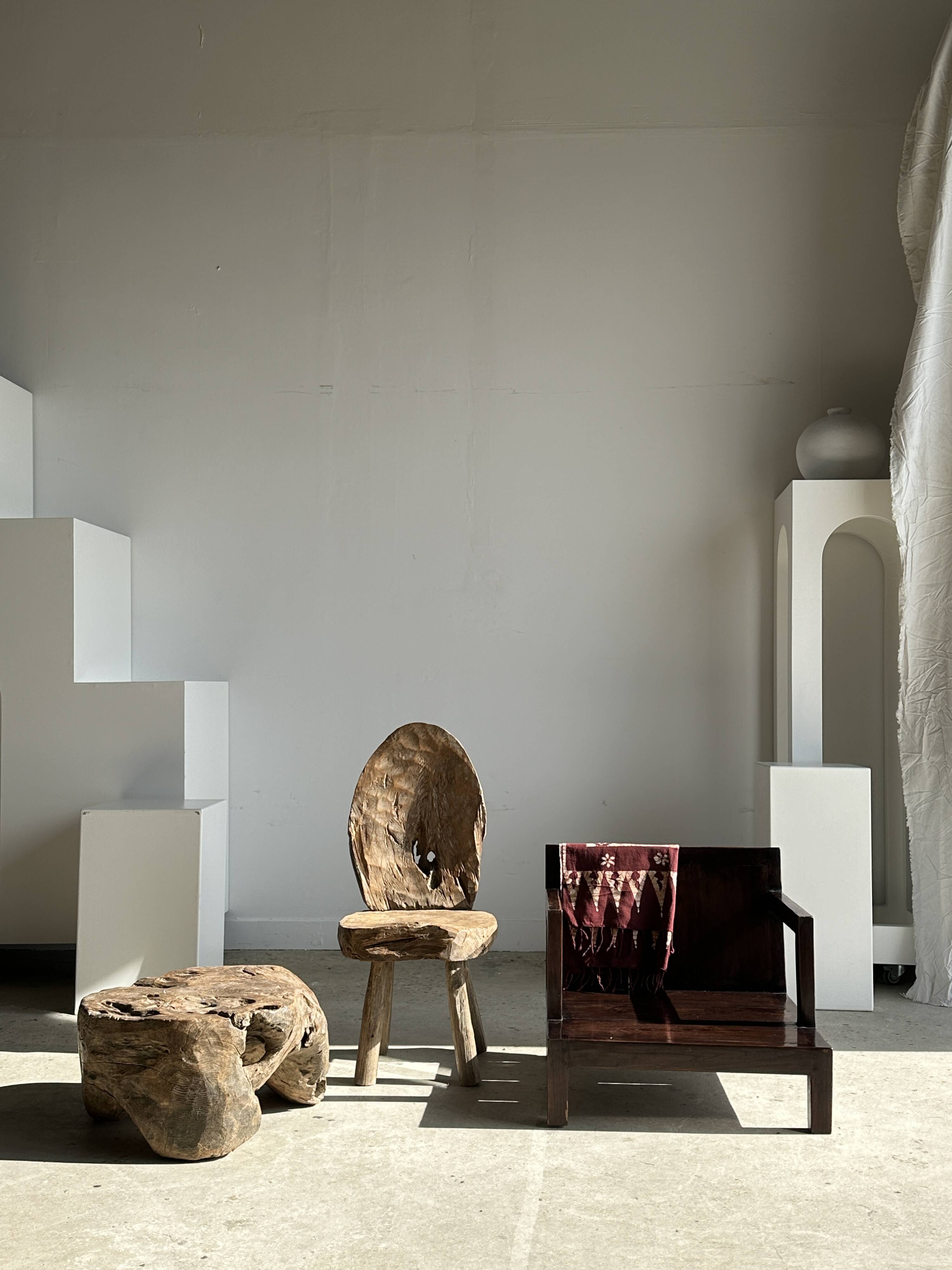 Small low armchair in varnished brown wood