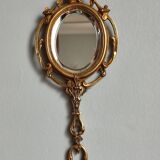 Antique hand-facing mirror in bronze and beveled glass