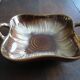 Square dish with brown and gold handles