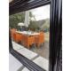 Black lacquered wood mirror "originally punctured"