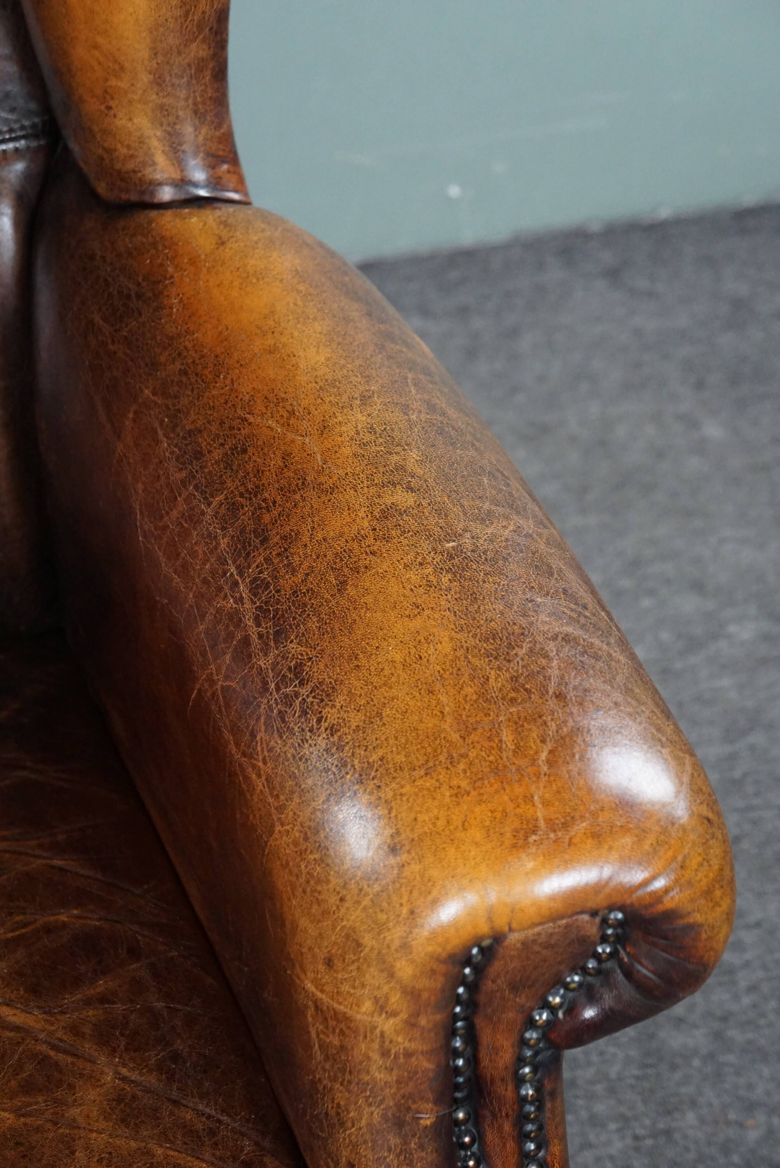 Dark wingback armchair made of sheep leather with stunning colors