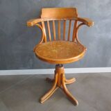 Old swivel office armchair in curved wood