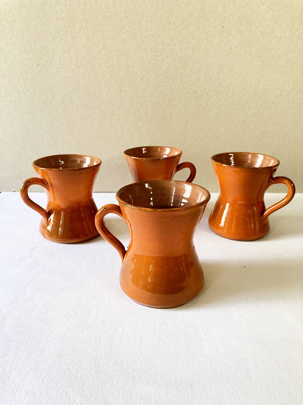 4 large orange enameled ceramic cups, signed