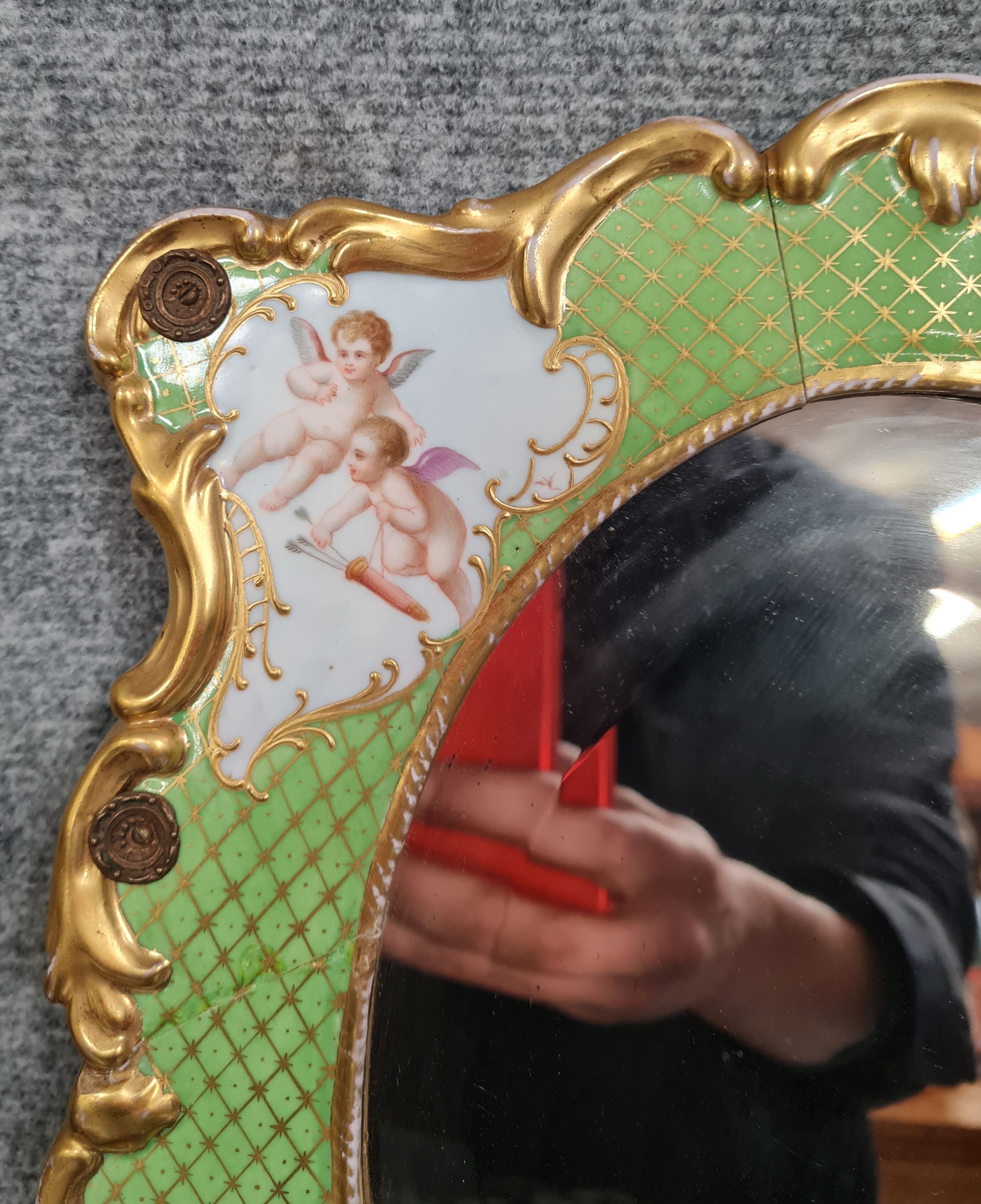 Porcelain mirror with cherub decorations circa 1900
