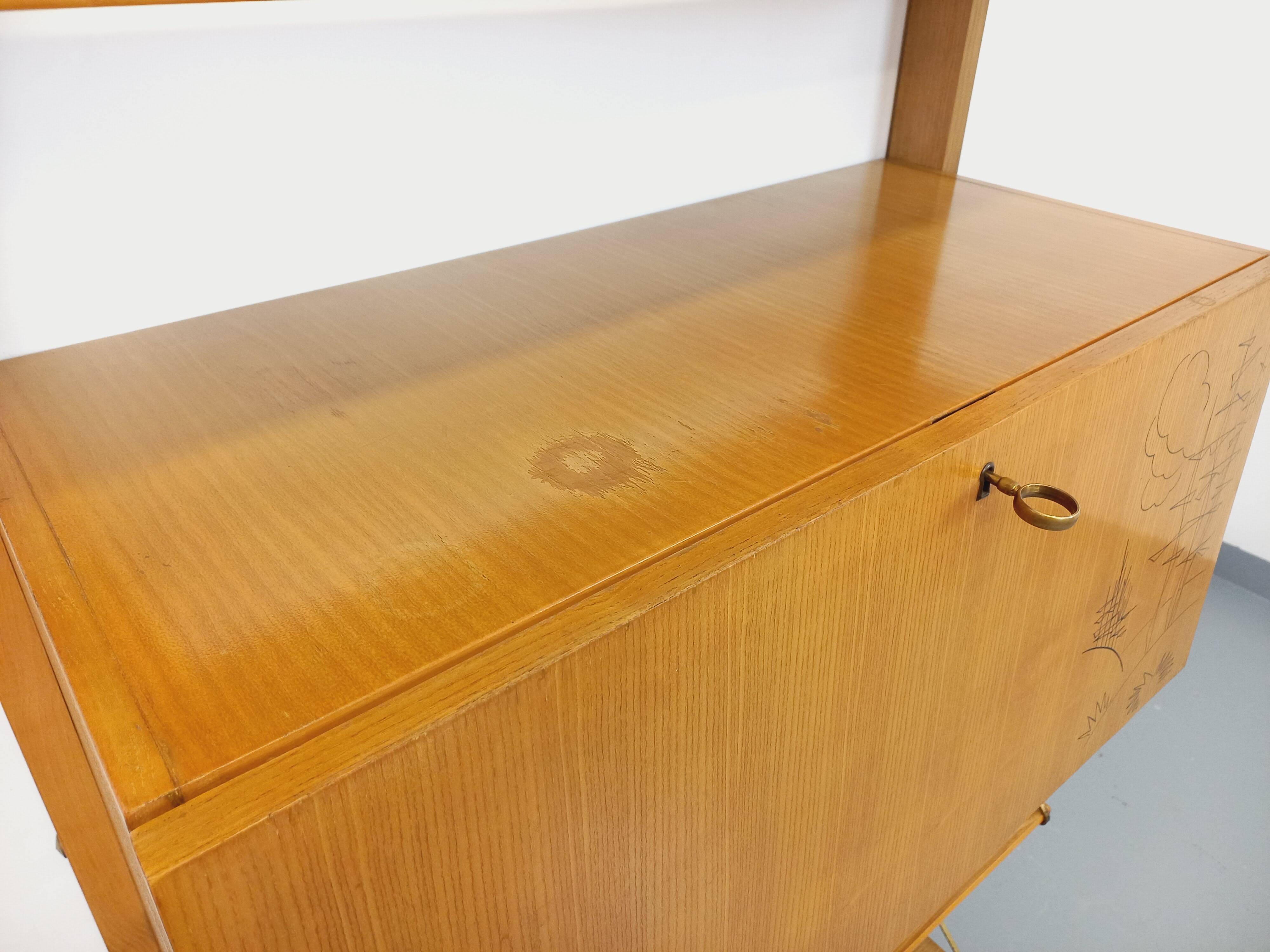 Wall shelf library with vintage light wood secretary bar
