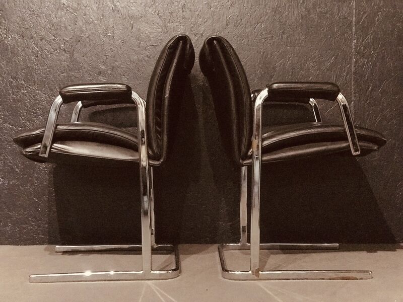 Pair of black leather Scandinavian armchairs