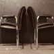 Pair of black leather Scandinavian armchairs