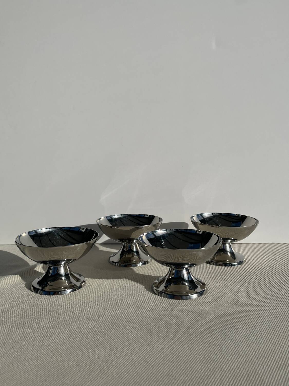 Set of 4 vintage metal ice cream glasses/cups on a stand.