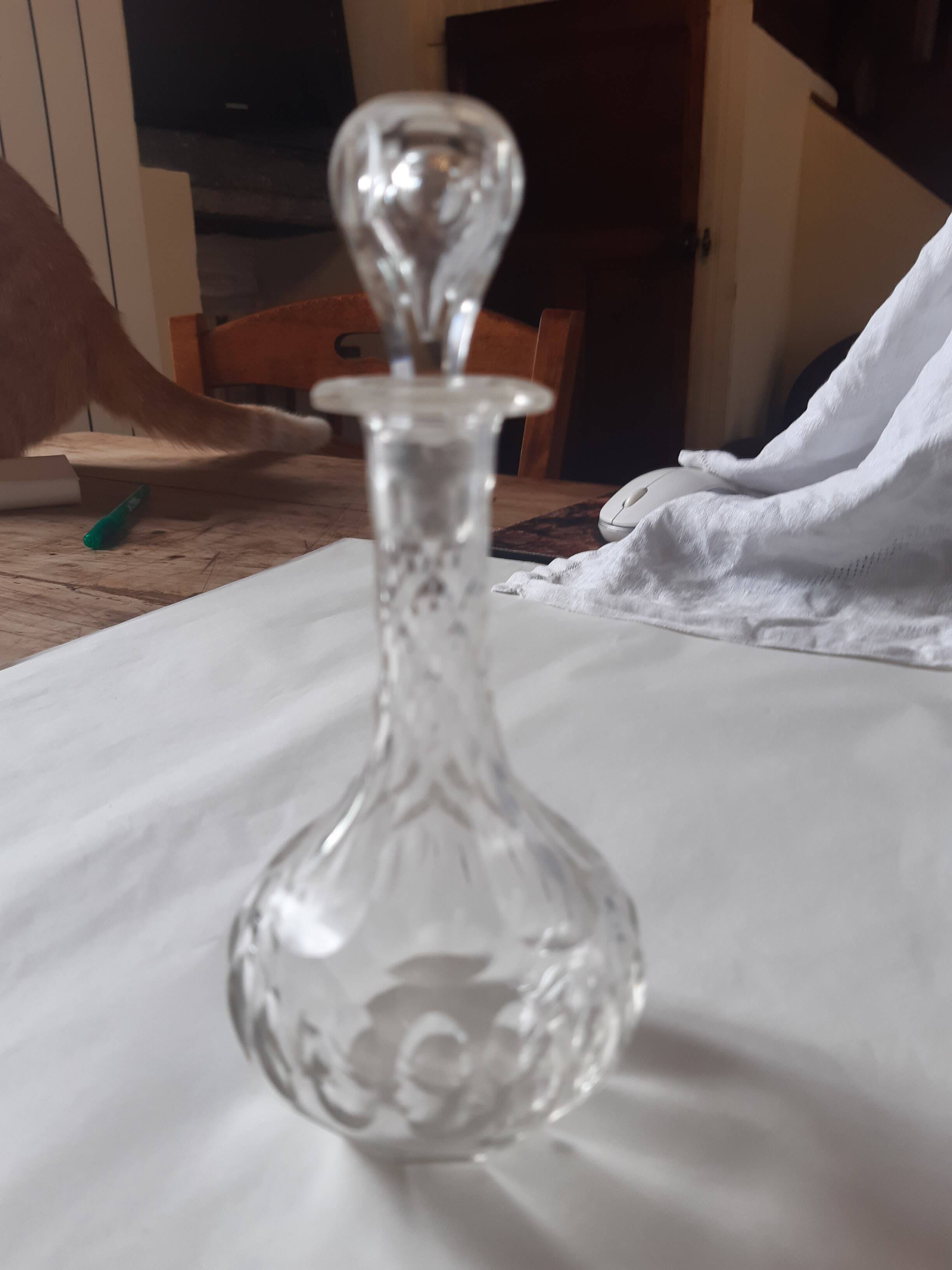 Cut crystal oil bottle with its crystal stopper.