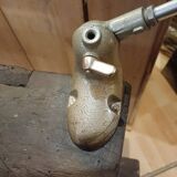 Small, very old, brutalist workbench equipped with a period workshop lamp