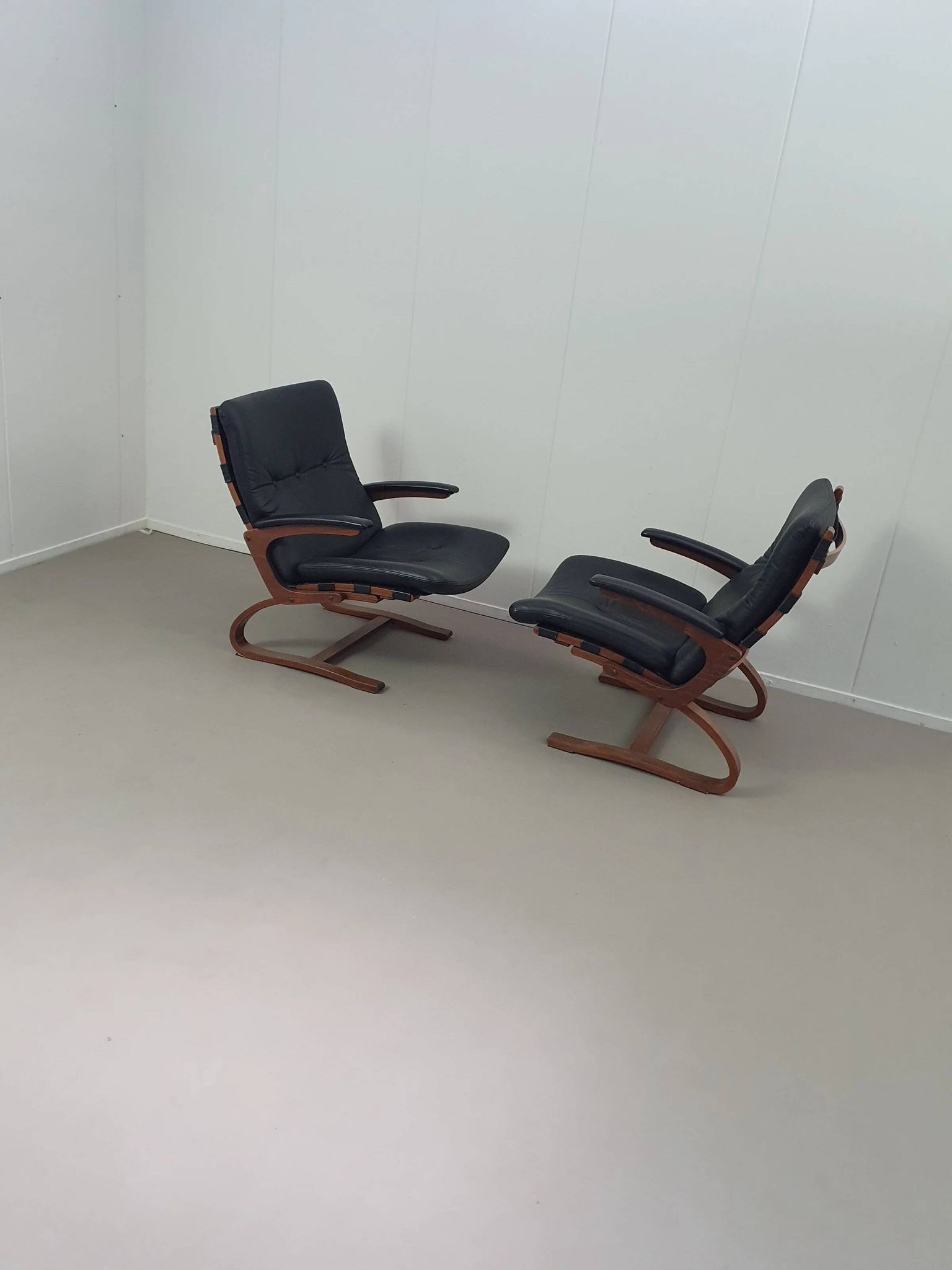 2 x Scandinavian black leather lounge chairs