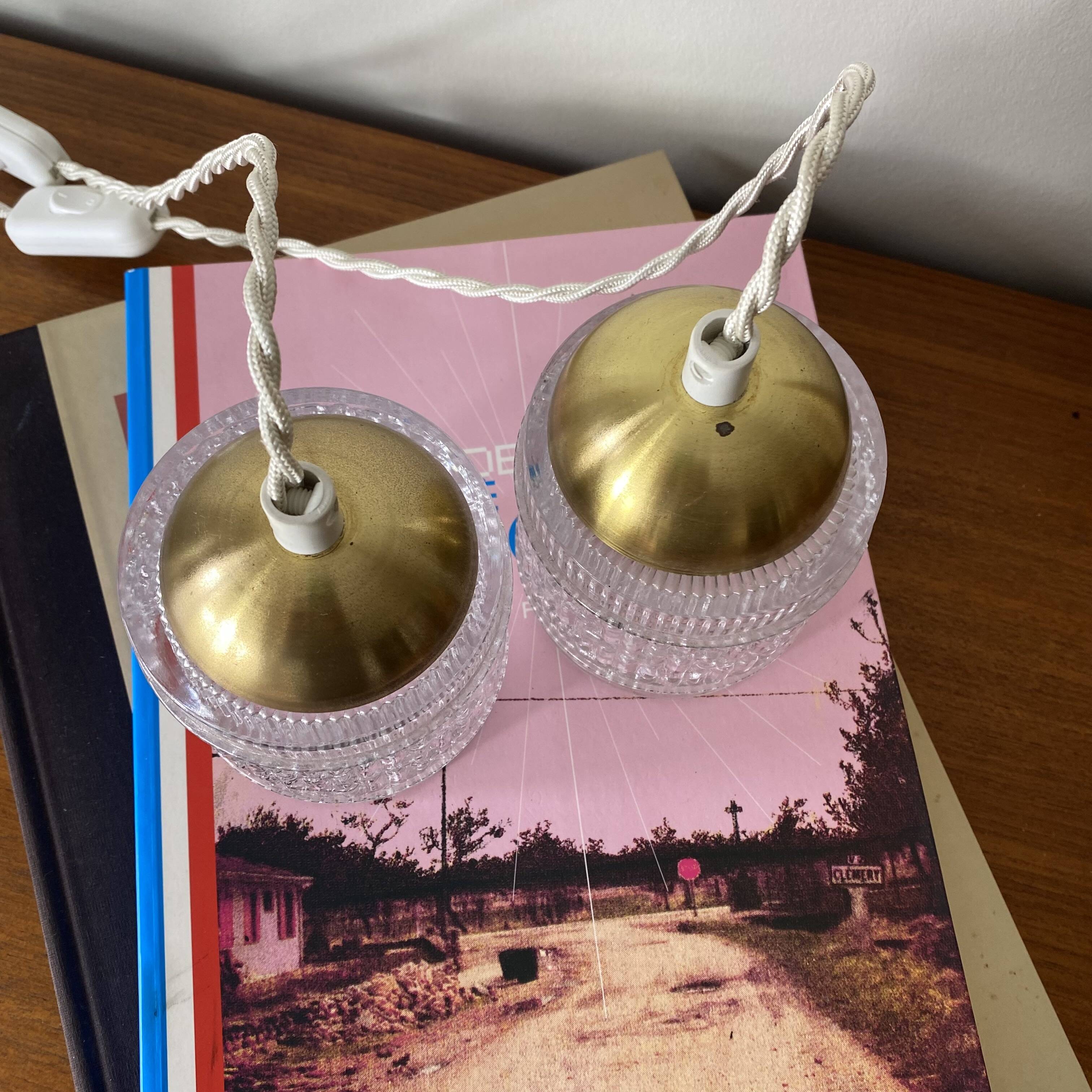 Pair of small portable tulip lamps in transparent glass.