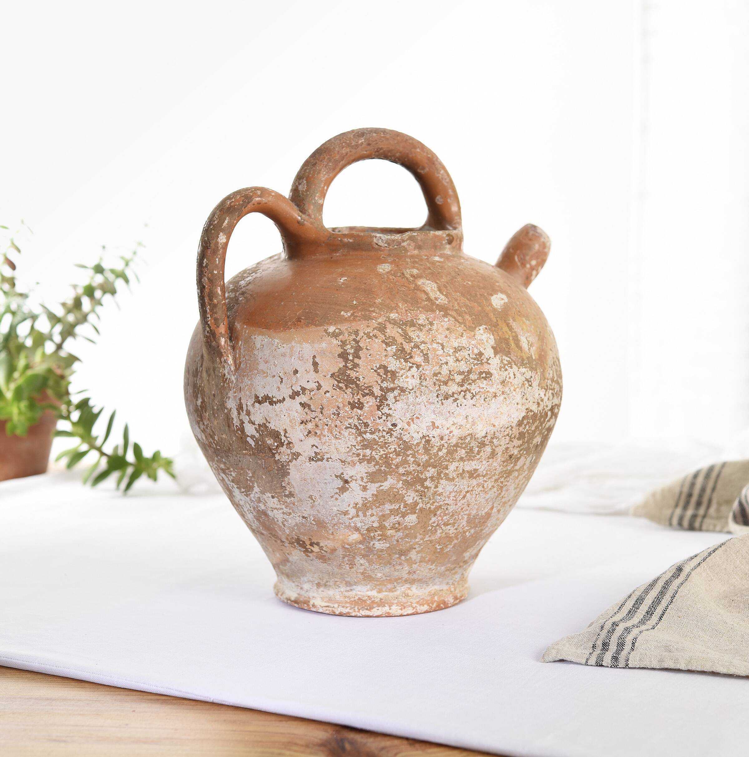 Old water jug. Gargoulette. Old terracotta pitcher.