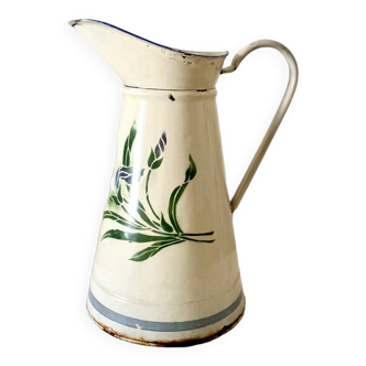 Old white enamelled pitcher with floral pattern decoration