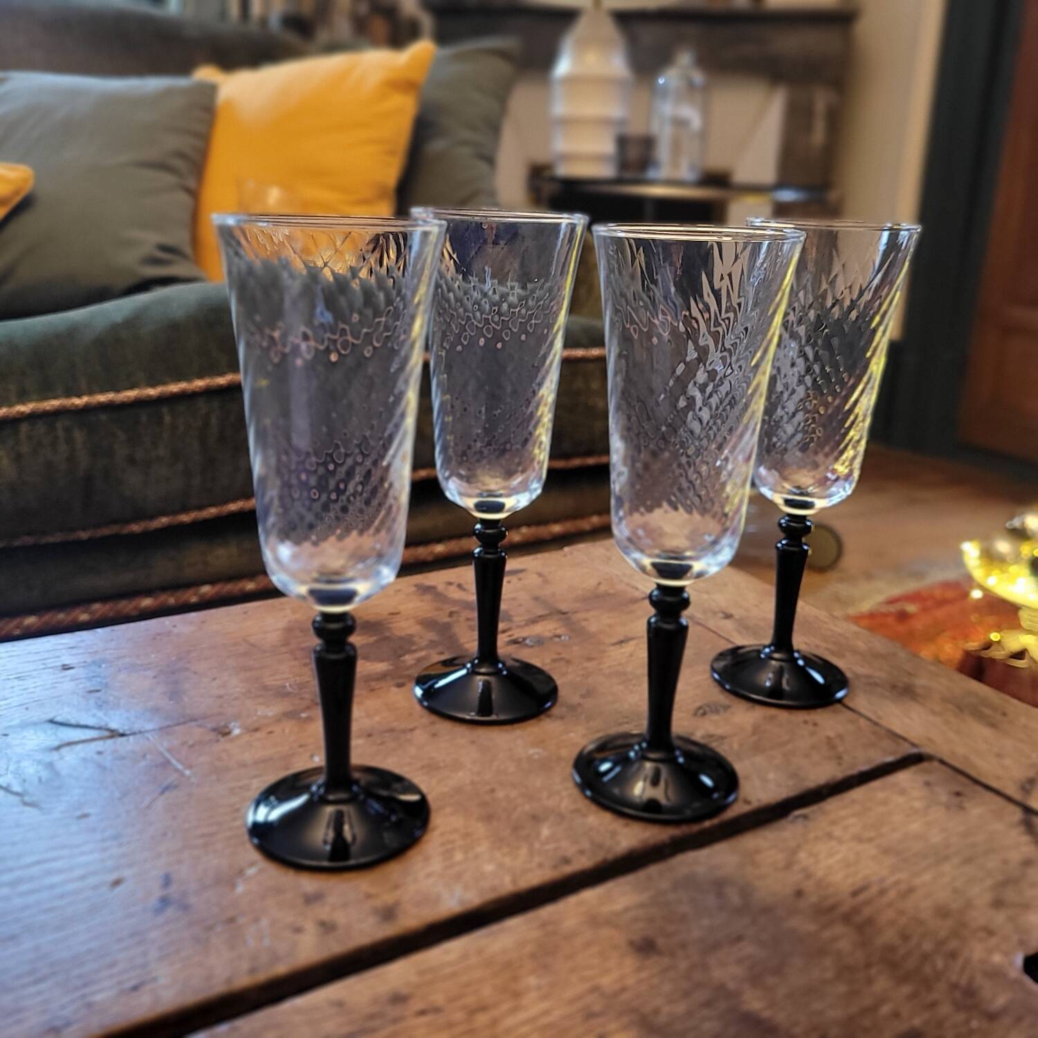 4 clear glass flutes with black stems. 1960–1970. 4 clear glass flutes with black stems.