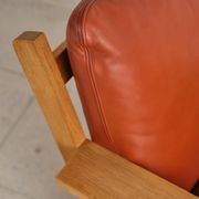 Brutalist armchair in oak and leather by Tage Poulsen, Denmark, 1970s.
