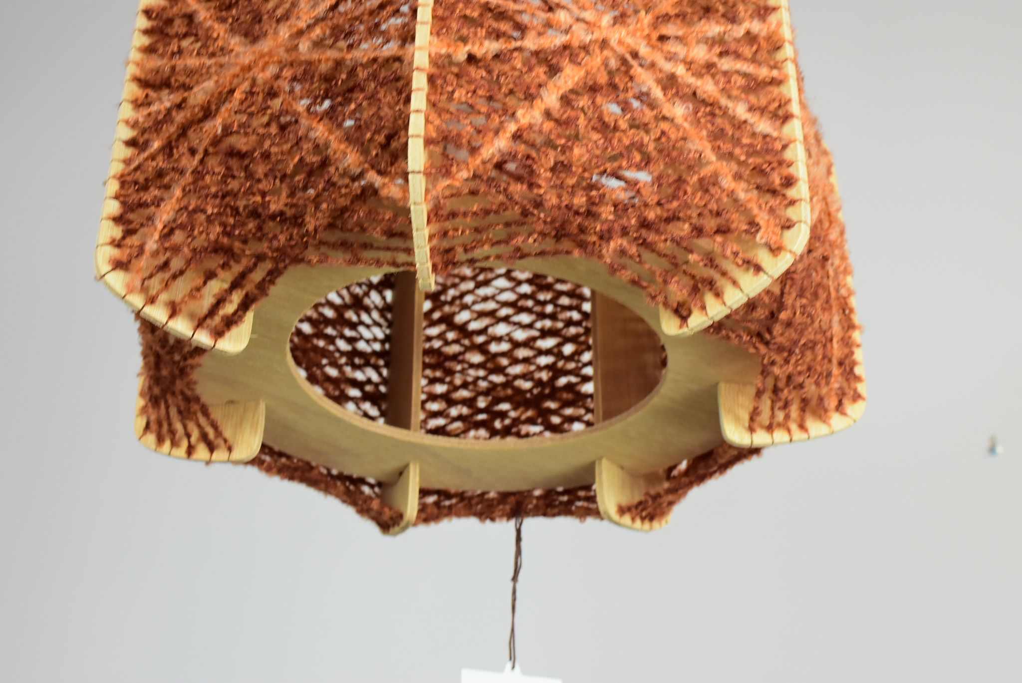 Brown wire and wood pendant light.