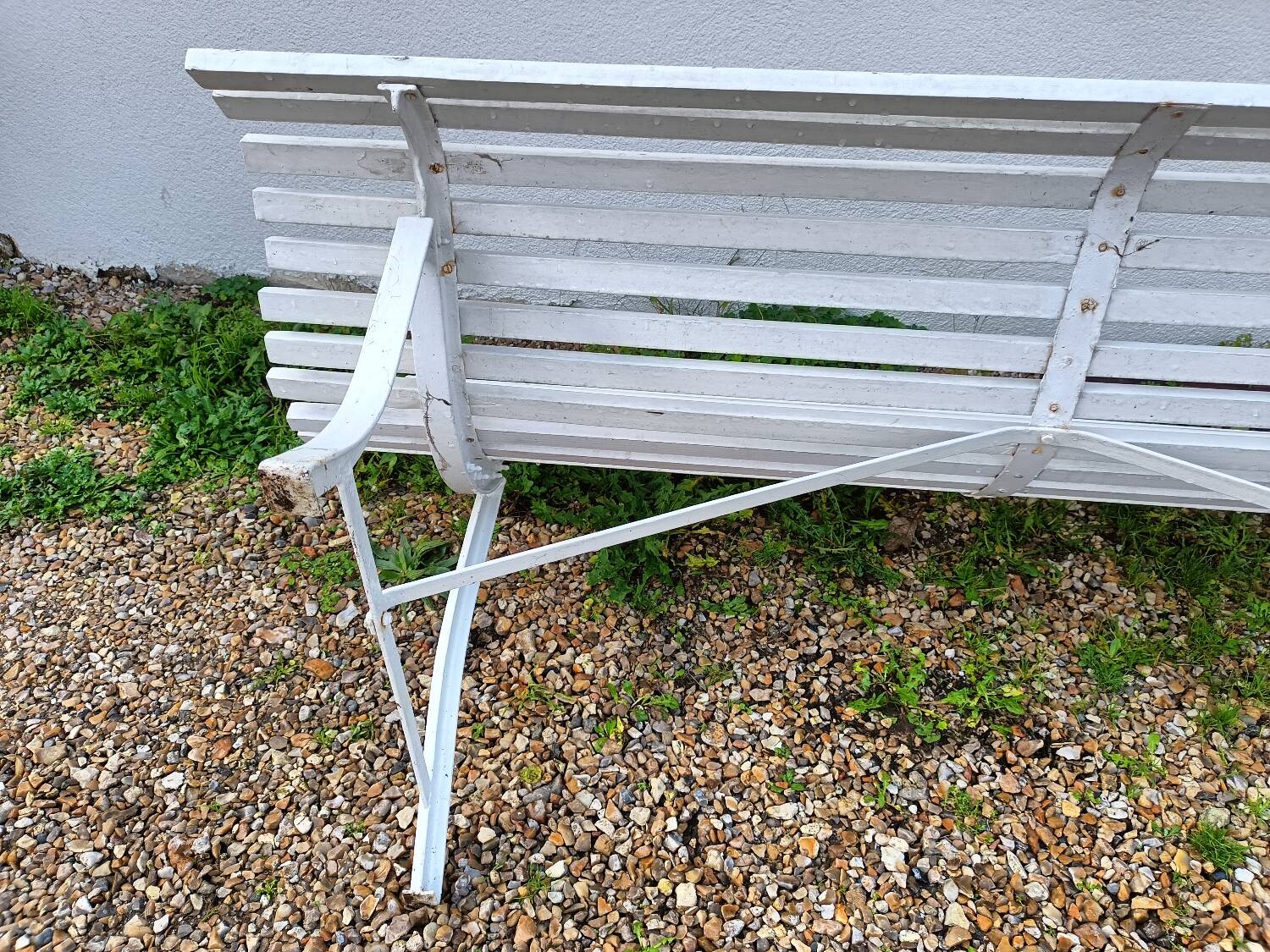 Old garden bench with metal legs and wooden slats
