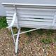 Old garden bench with metal legs and wooden slats