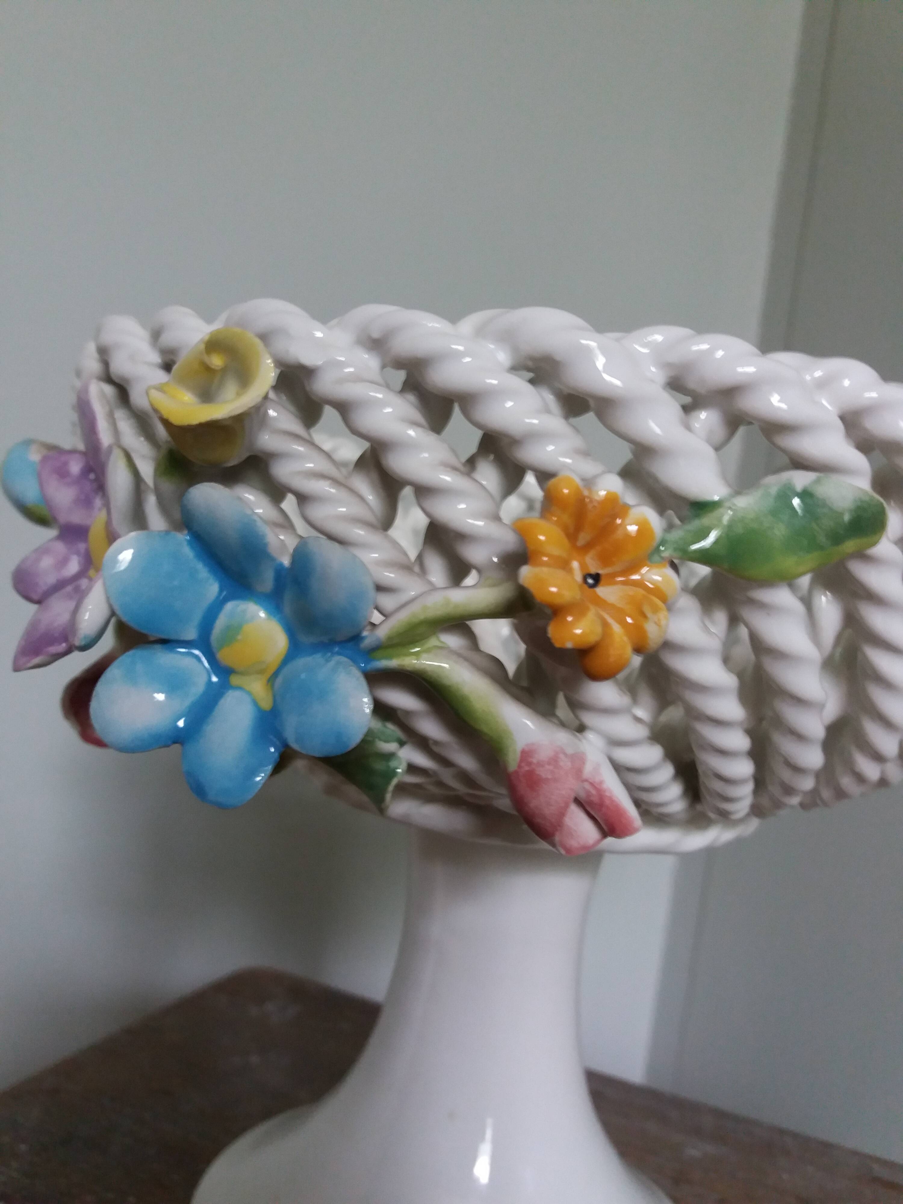 Cup on woven ceramic base with slip flowers