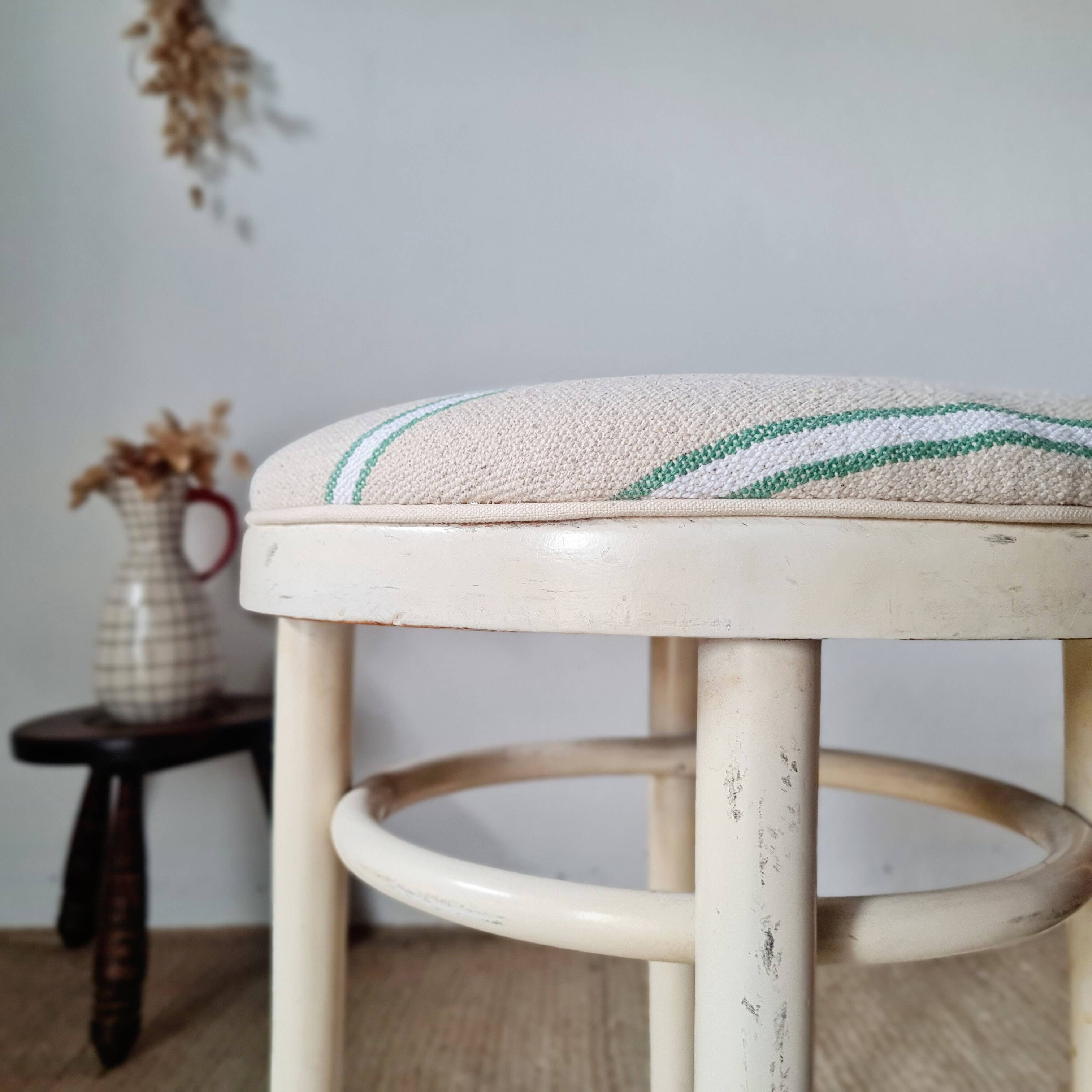Vintage curved wooden stool in Baumann style, striped fabric seat.