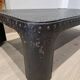 Industrial coffee table in riveted metal from around 1920 – black patina – 145 × 80 cm