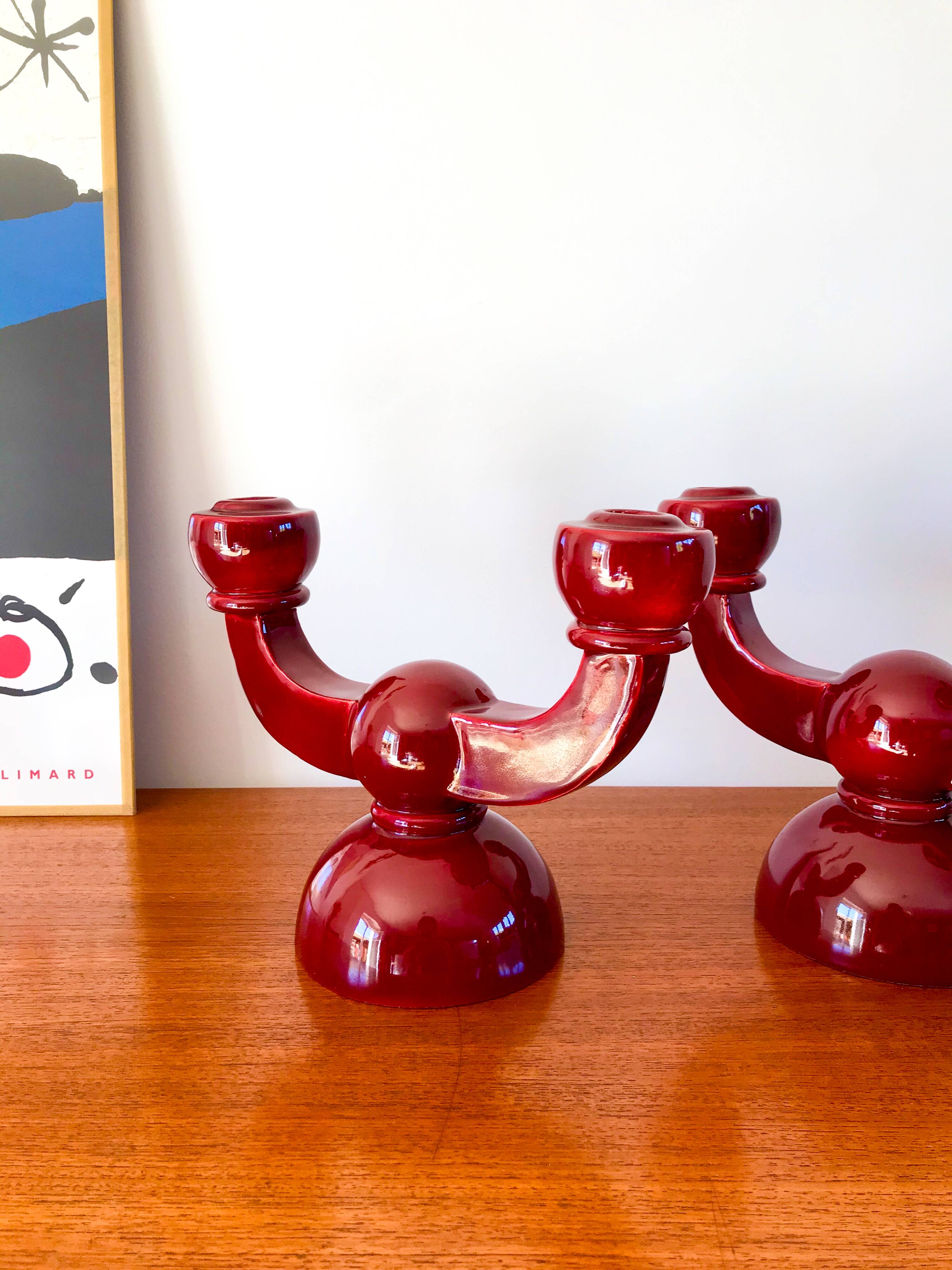 pair of burgundy enameled ceramic candlesticks / candelabras signed 1949